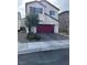 Two-story house with red garage door and landscaping at 9159 Oxford Blue Ave, Las Vegas, NV 89148