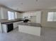 Kitchen island with granite countertops and white cabinets at 9159 Oxford Blue Ave, Las Vegas, NV 89148