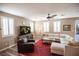 Bright living room with sectional sofa, wood coffee table, and large TV at 926 Hidden Bull St, Las Vegas, NV 89178