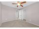 Simple bedroom with ceiling fan and mirrored closet doors at 9505 Windsor Forest Ct, Las Vegas, NV 89123