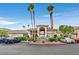 Attractive community entrance with palm trees and ample parking at 9901 Trailwood Dr # 1058, Las Vegas, NV 89134