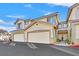 Tan colored, three-unit building with attached garages at 9901 Trailwood Dr # 1058, Las Vegas, NV 89134