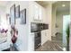 Modern wet bar with white cabinets and granite countertop at 2818 Belmont Dr, Henderson, NV 89074