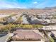 Aerial view of house and neighborhood, desert landscape at 10397 Station Creek Cir, Las Vegas, NV 89178