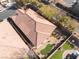 Aerial view of single-story house with tile roof, landscaping, and desert mountain views at 10397 Station Creek Cir, Las Vegas, NV 89178