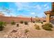 Landscaped backyard with a rock pathway and desert plants at 10397 Station Creek Cir, Las Vegas, NV 89178