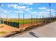 Beautiful baseball field view surrounded by protective fence with a background of desert landscape under bright blue skies at 10397 Station Creek Cir, Las Vegas, NV 89178