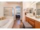Elegant bathroom with a soaking tub, double vanity, and separate shower at 10397 Station Creek Cir, Las Vegas, NV 89178
