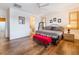 Large bedroom with hardwood floors, a king-size bed, and en-suite bathroom at 10397 Station Creek Cir, Las Vegas, NV 89178