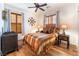 Bright bedroom with striped bedding and wood flooring at 10397 Station Creek Cir, Las Vegas, NV 89178