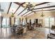 Spacious club room featuring dining tables, chandeliers, and abundant natural light for social gatherings at 10397 Station Creek Cir, Las Vegas, NV 89178