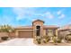 Single story home with a brown garage door and well-manicured landscaping at 10397 Station Creek Cir, Las Vegas, NV 89178