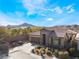 Single-story home with brown tile roof, stone accents, and landscaped front yard at 10397 Station Creek Cir, Las Vegas, NV 89178