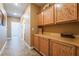 Bright hallway with wood cabinets and tile flooring at 10397 Station Creek Cir, Las Vegas, NV 89178