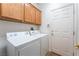 Laundry room with washer, dryer, and overhead cabinets at 10397 Station Creek Cir, Las Vegas, NV 89178