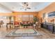 Open living room with a comfortable seating area and large windows at 10397 Station Creek Cir, Las Vegas, NV 89178