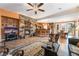 Living room features a stone fireplace, hardwood floors and an open floor plan at 10397 Station Creek Cir, Las Vegas, NV 89178