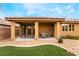 Covered patio with seating area and table, next to the house at 10397 Station Creek Cir, Las Vegas, NV 89178