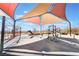 Modern community playground featuring shaded play areas with cable bridge and climbing structure at 10397 Station Creek Cir, Las Vegas, NV 89178