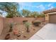 Landscaped side yard with desert plants and a bench at 10397 Station Creek Cir, Las Vegas, NV 89178