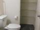 Bathroom with toilet, shelving, and dark gray floor tiles at 11173 Hickory Glen St, Las Vegas, NV 89179