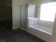 Bathroom with shower, bathtub, and gray floor tiles at 11173 Hickory Glen St, Las Vegas, NV 89179