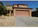 Two story house with attached garage and desert landscaping at 11173 Hickory Glen St, Las Vegas, NV 89179