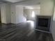 Living room with hardwood floors and fireplace, view of staircase at 11173 Hickory Glen St, Las Vegas, NV 89179