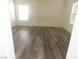 Spacious living room with wood-look floors and large window at 11173 Hickory Glen St, Las Vegas, NV 89179