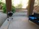 Covered patio with grill and seating, overlooking a desert landscape at 11173 Hickory Glen St, Las Vegas, NV 89179