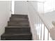 Upstairs view of stairs with white railing and gray wood-look treads at 11173 Hickory Glen St, Las Vegas, NV 89179