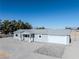 Single-story home with gray exterior and paved driveway at 1280 E Carson, Pahrump, NV 89048