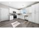 Modern kitchen with white cabinets, stainless steel appliances, and gray flooring at 1280 E Carson, Pahrump, NV 89048