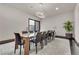 Formal dining room with large table and modern light fixture at 1341 Villa Barolo Ave, Henderson, NV 89052