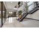 Bright entryway features a modern staircase and glass doors at 1341 Villa Barolo Ave, Henderson, NV 89052