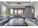 Gathering room with leather sofas, large windows, and pool view at 1341 Villa Barolo Ave, Henderson, NV 89052