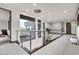 Modern hallway with metal railing and a contemporary light fixture at 1341 Villa Barolo Ave, Henderson, NV 89052