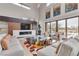 Open living space featuring a fireplace and large windows at 1341 Villa Barolo Ave, Henderson, NV 89052