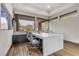 Modern office features a large white desk, two chairs, and wood flooring at 1341 Villa Barolo Ave, Henderson, NV 89052