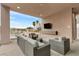 Covered patio with seating and outdoor TV at 1341 Villa Barolo Ave, Henderson, NV 89052