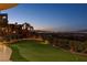 Landscaped backyard with putting green and city views at 1480 Macdonald Ranch Dr, Henderson, NV 89012