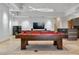 Game room with pool table, bar, and large screen TV at 1480 Macdonald Ranch Dr, Henderson, NV 89012