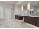 Luxurious bathroom with double vanity, marble floors, and large mirrors at 1480 Macdonald Ranch Dr, Henderson, NV 89012