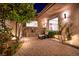 Night view of backyard with pond, landscaping, and lighting at 1480 Macdonald Ranch Dr, Henderson, NV 89012