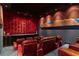 Home theater with red leather seating and large screen at 1480 Macdonald Ranch Dr, Henderson, NV 89012