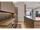 Modern kitchen with dark wood cabinets and stone countertops at 1480 Macdonald Ranch Dr, Henderson, NV 89012