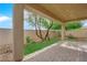 Charming covered patio with brick pavers and views of the landscaped backyard at 2033 Old Field Ave, North Las Vegas, NV 89081