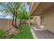 This covered patio showcases a manicured garden and easy access to the home at 2033 Old Field Ave, North Las Vegas, NV 89081