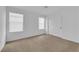 Cozy bedroom features neutral carpet, closet, and bright natural light from two windows at 2033 Old Field Ave, North Las Vegas, NV 89081