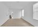 An empty bedroom with two windows, a door, and carpeted floors at 2033 Old Field Ave, North Las Vegas, NV 89081